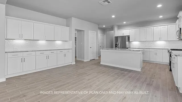 a kitchen with white cabinets stainless steel appliances and sink