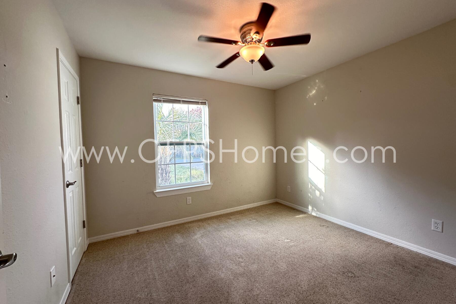 932 Emily Circle Fort Walton Beach, FL 32547 - Photo 12 of 20 en empty room with windows and ceiling fan