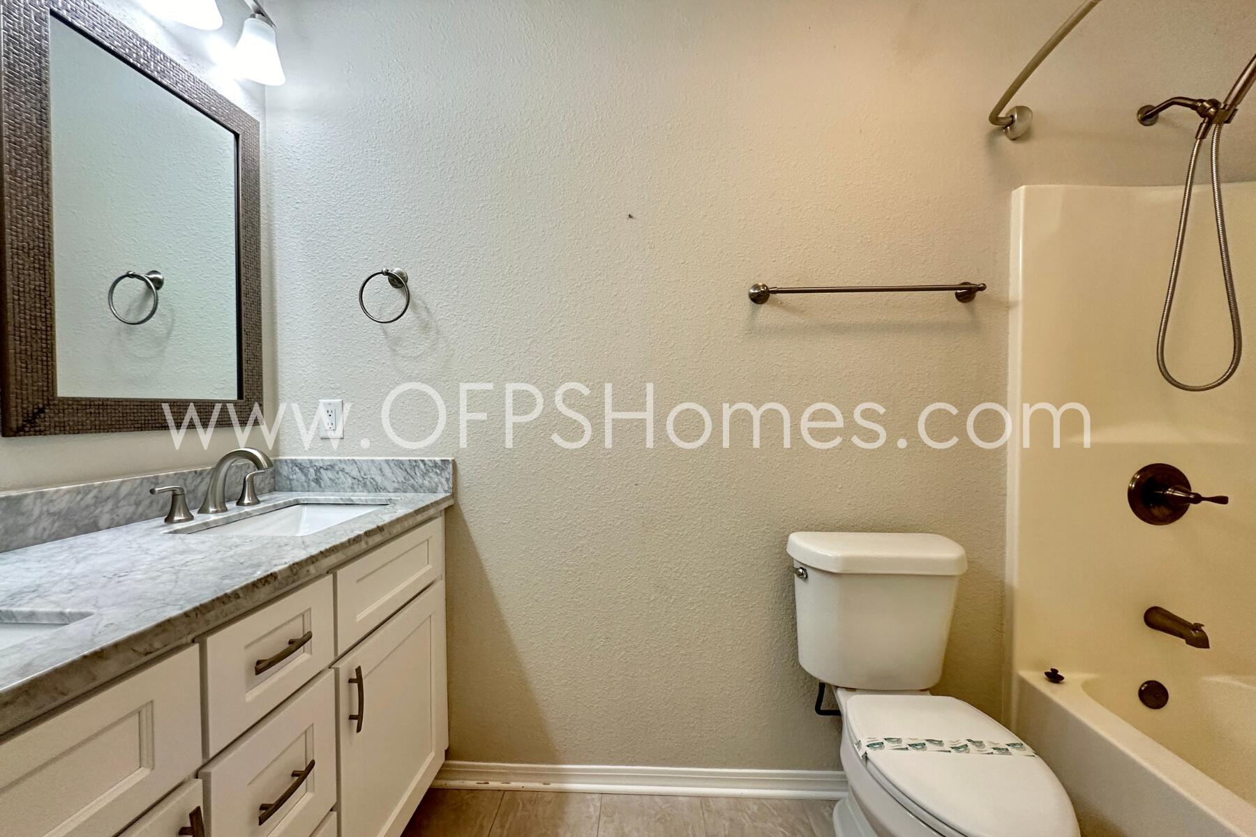 932 Emily Circle Fort Walton Beach, FL 32547 - Photo 16 of 20 a bathroom with a toilet sink shower and mirror