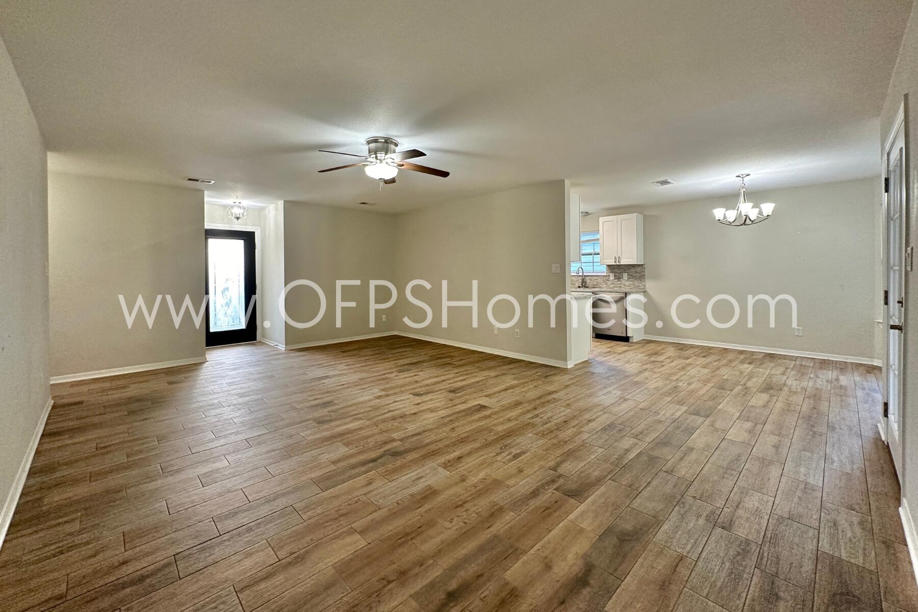 932 Emily Circle Fort Walton Beach, FL 32547 - Photo 3 of 20 a view of a livingroom with hardwood floor and a ceiling fan