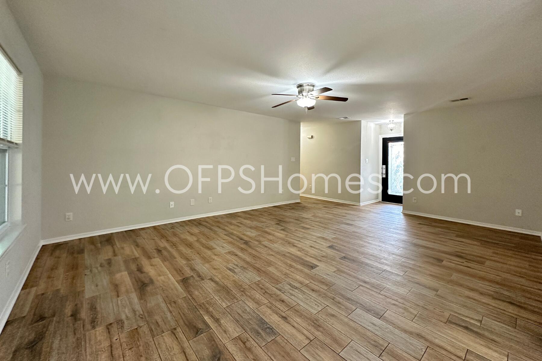 932 Emily Circle Fort Walton Beach, FL 32547 - Photo 4 of 20 a view of an empty room with wooden floor