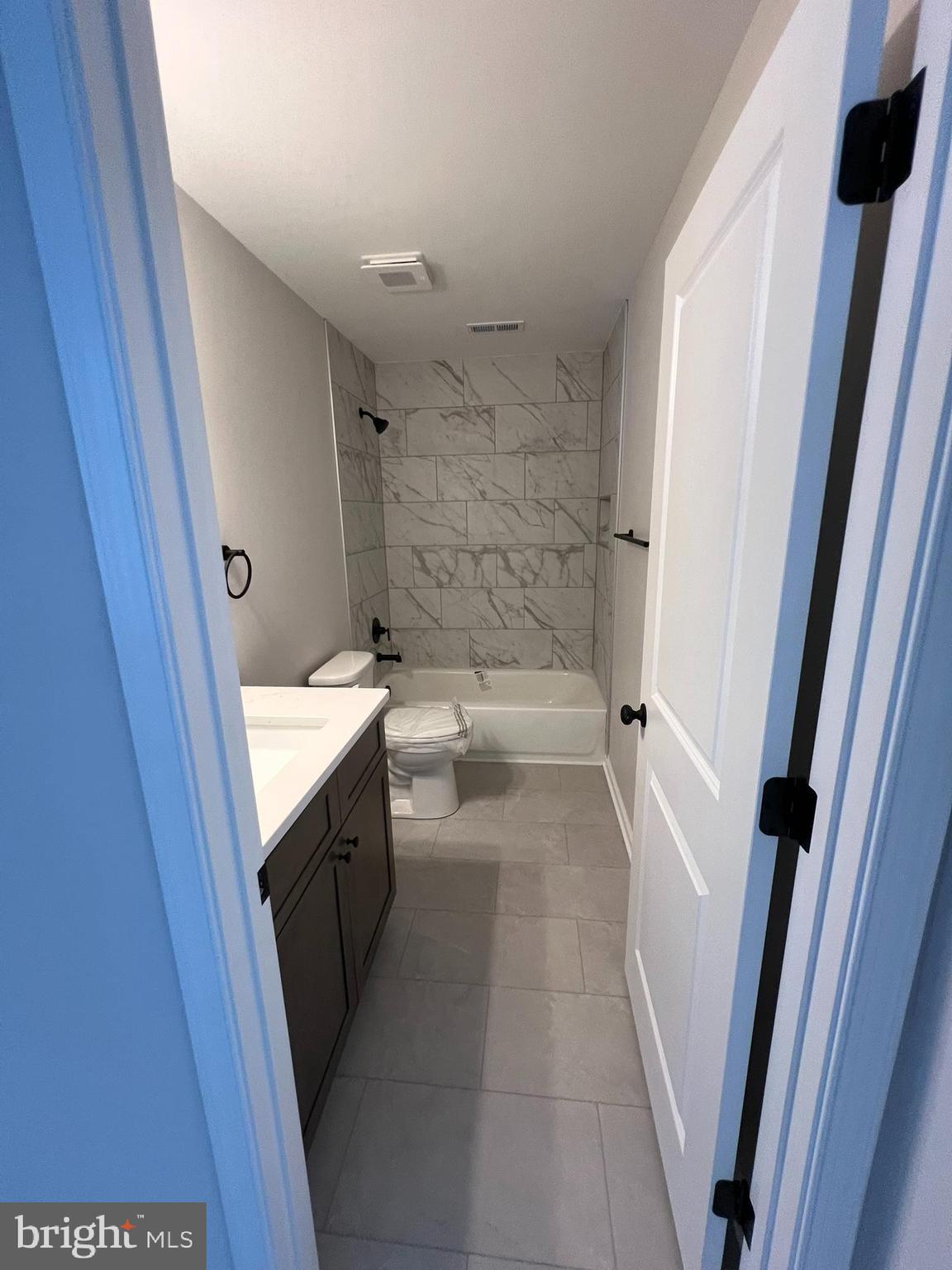 515 South Spring Street Martinsburg, WV 25401 - Photo 14 of 20 a bathroom with a granite countertop sink toilet and shower