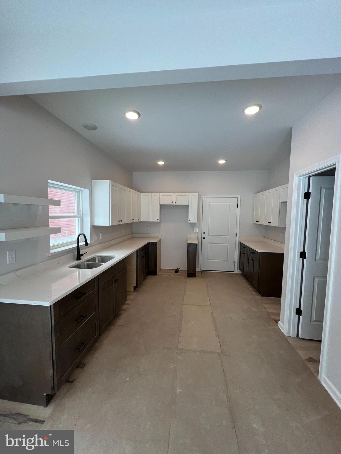 515 South Spring Street Martinsburg, WV 25401 - Photo 2 of 20 a large white kitchen with a sink and cabinets