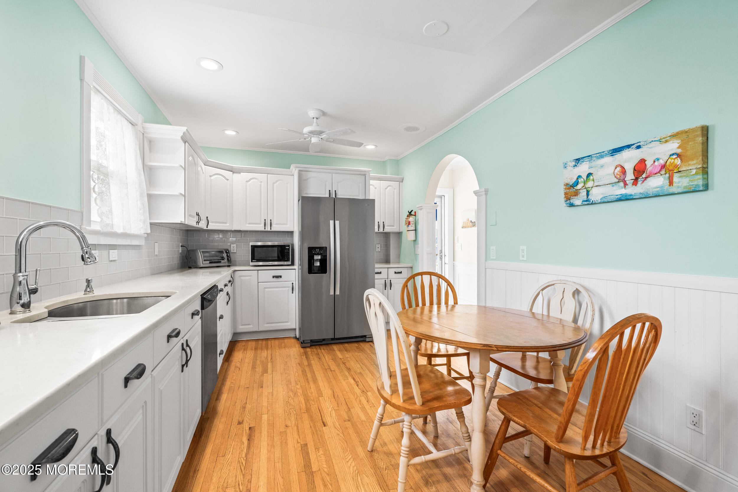 18 Abbott Avenue Ocean Grove, NJ 07756 - Photo 37 of 84 a kitchen with stainless steel appliances granite countertop a dining table chairs sink refrigerator and microwave