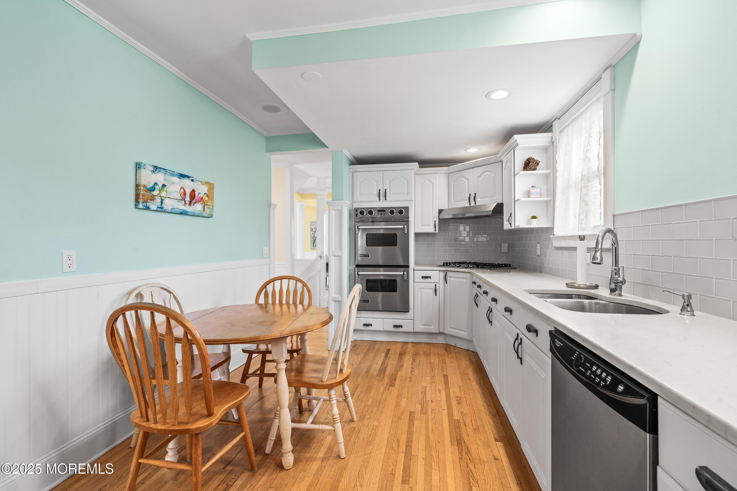 18 Abbott Avenue Ocean Grove, NJ 07756 - Photo 39 of 84 a kitchen with stainless steel appliances granite countertop a sink a stove a dining table and chairs with wooden floor