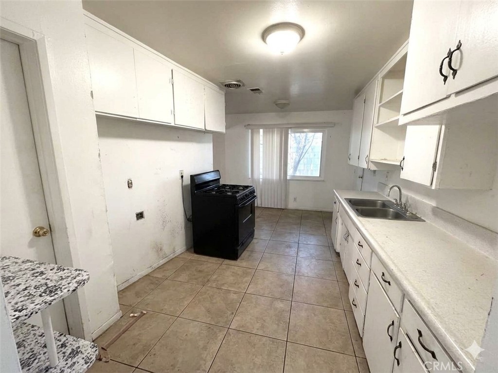 8868 Randolph Street Riverside, CA 92503 - Photo 4 of 21 Original Photo of kitchen, AI digitally altered to remove minor debris