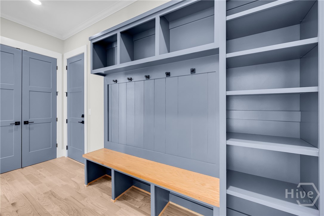 2476 St Martin Way Monroe, GA 30656 - Photo 30 of 75 Integrated custom built-in cabinetry featuring shelving, coat hooks, and a wooden bench