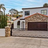 a view of a white house with a yard and garage