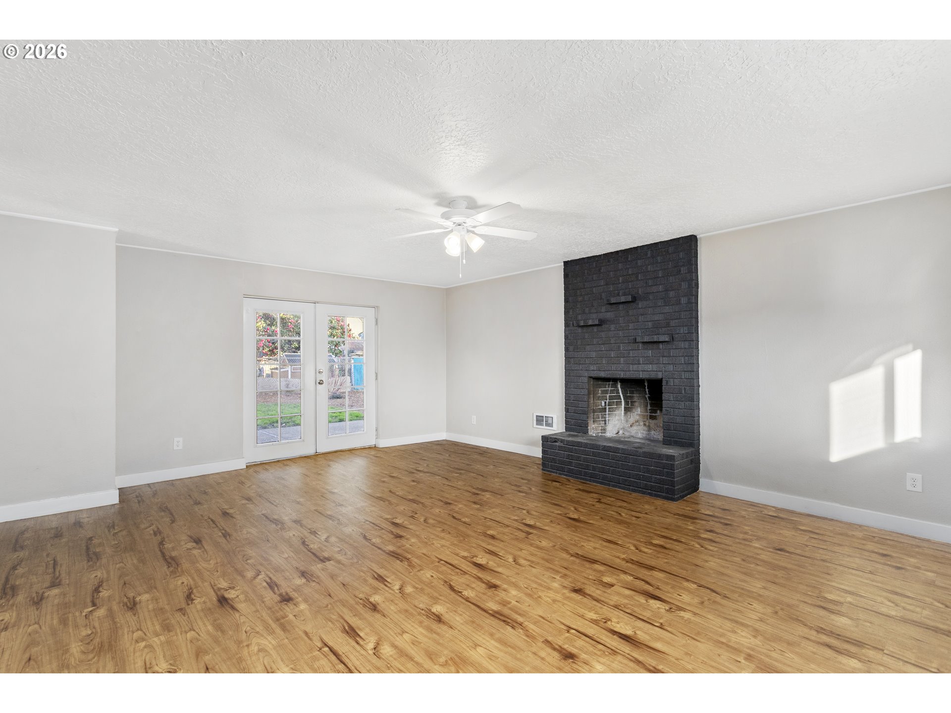 8705 Southeast Pardee Street Portland, OR 97266 - Photo 12 of 32 a view of empty room with window and fireplace