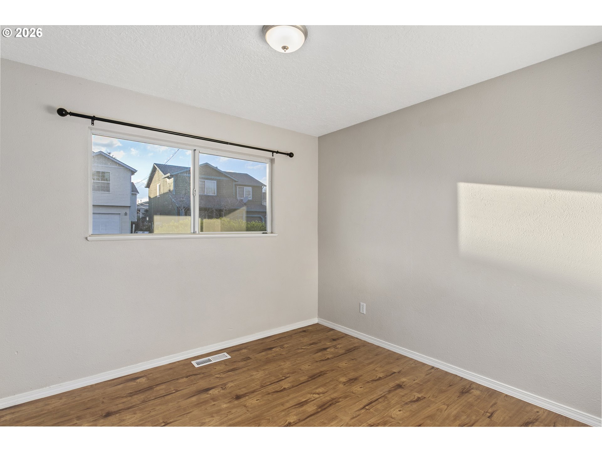 8705 Southeast Pardee Street Portland, OR 97266 - Photo 17 of 32 an empty room with a window