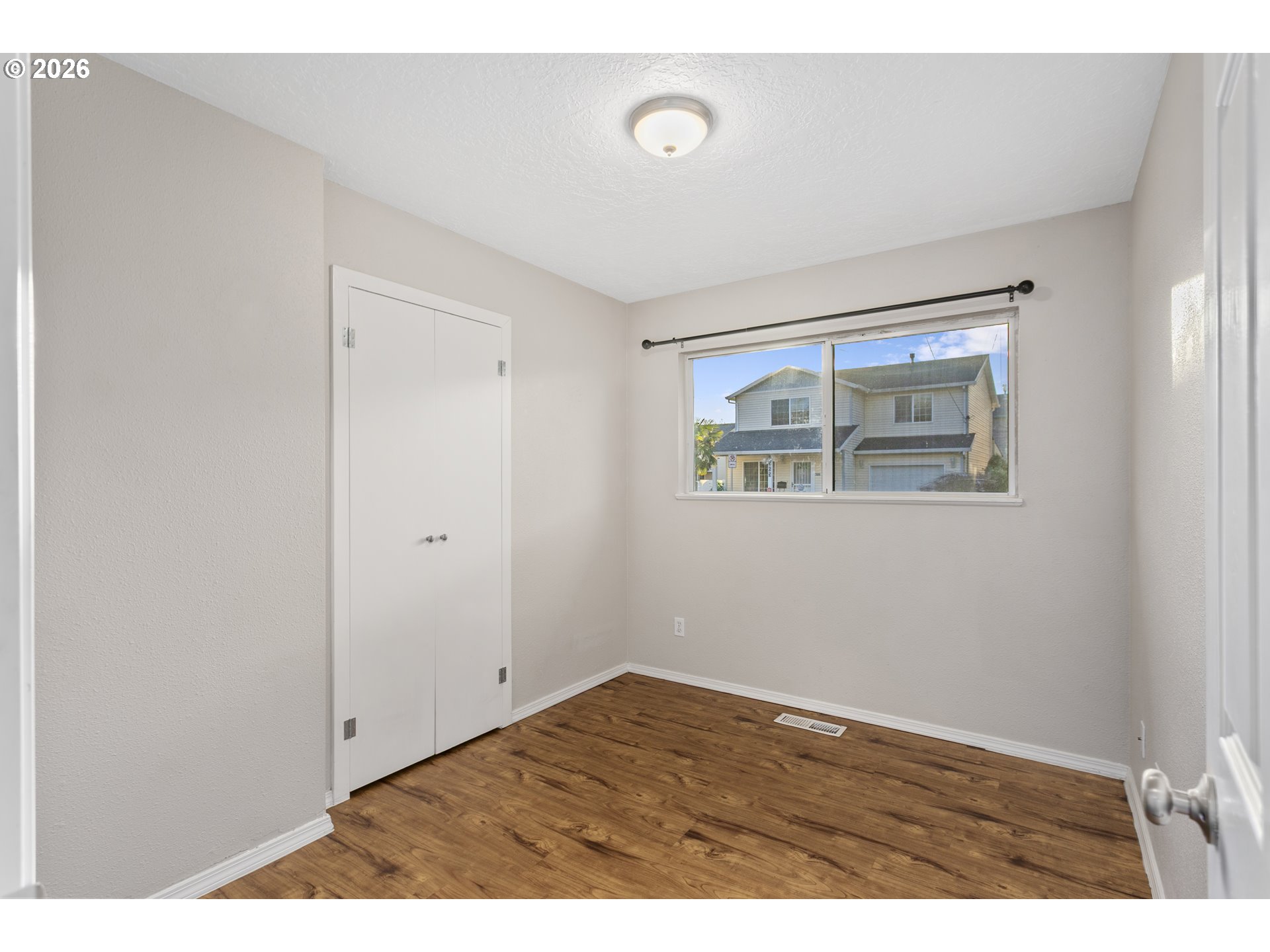 8705 Southeast Pardee Street Portland, OR 97266 - Photo 23 of 32 a view of an empty room with wooden floor