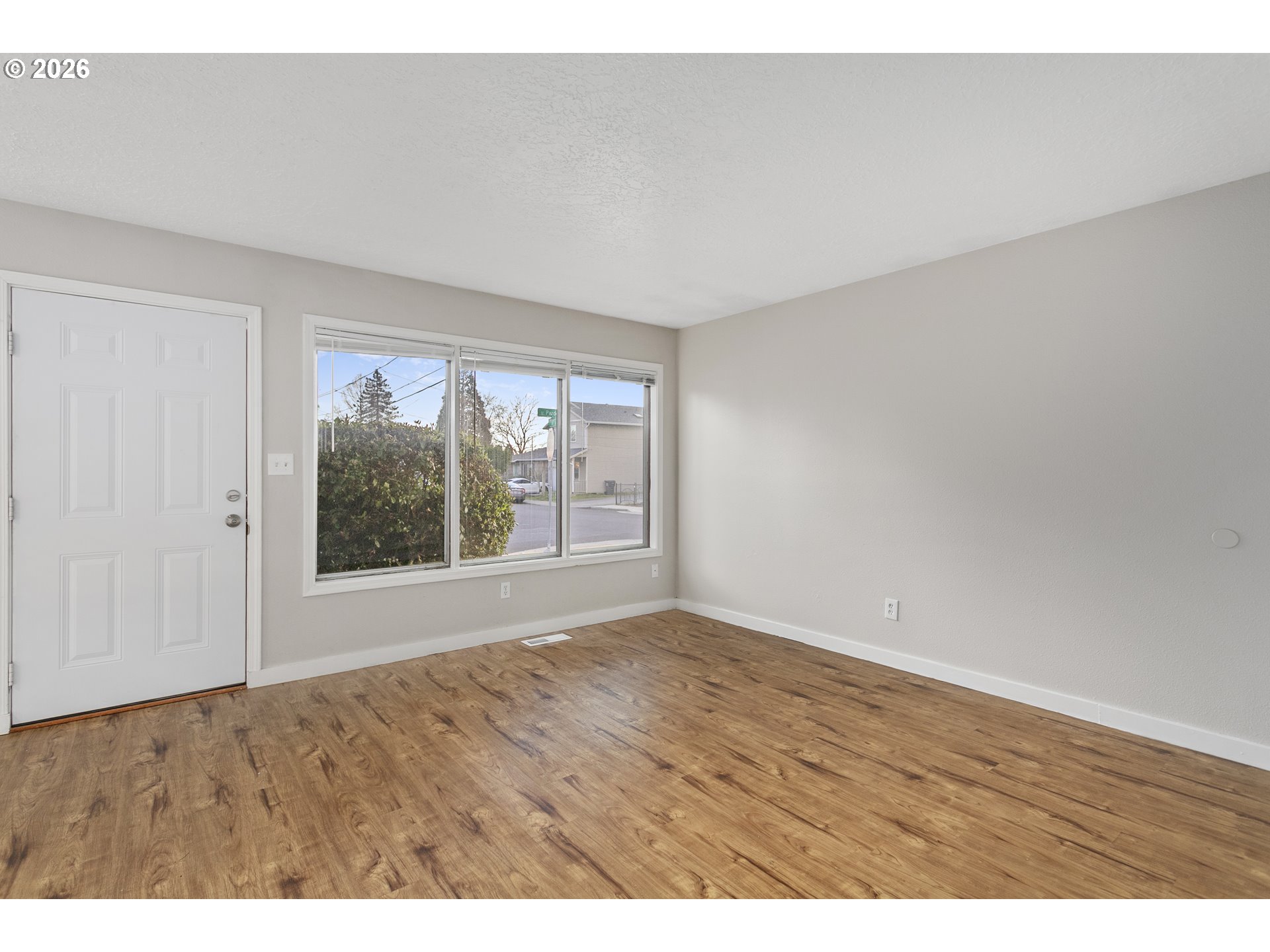 8705 Southeast Pardee Street Portland, OR 97266 - Photo 3 of 32 a view of an empty room with a window