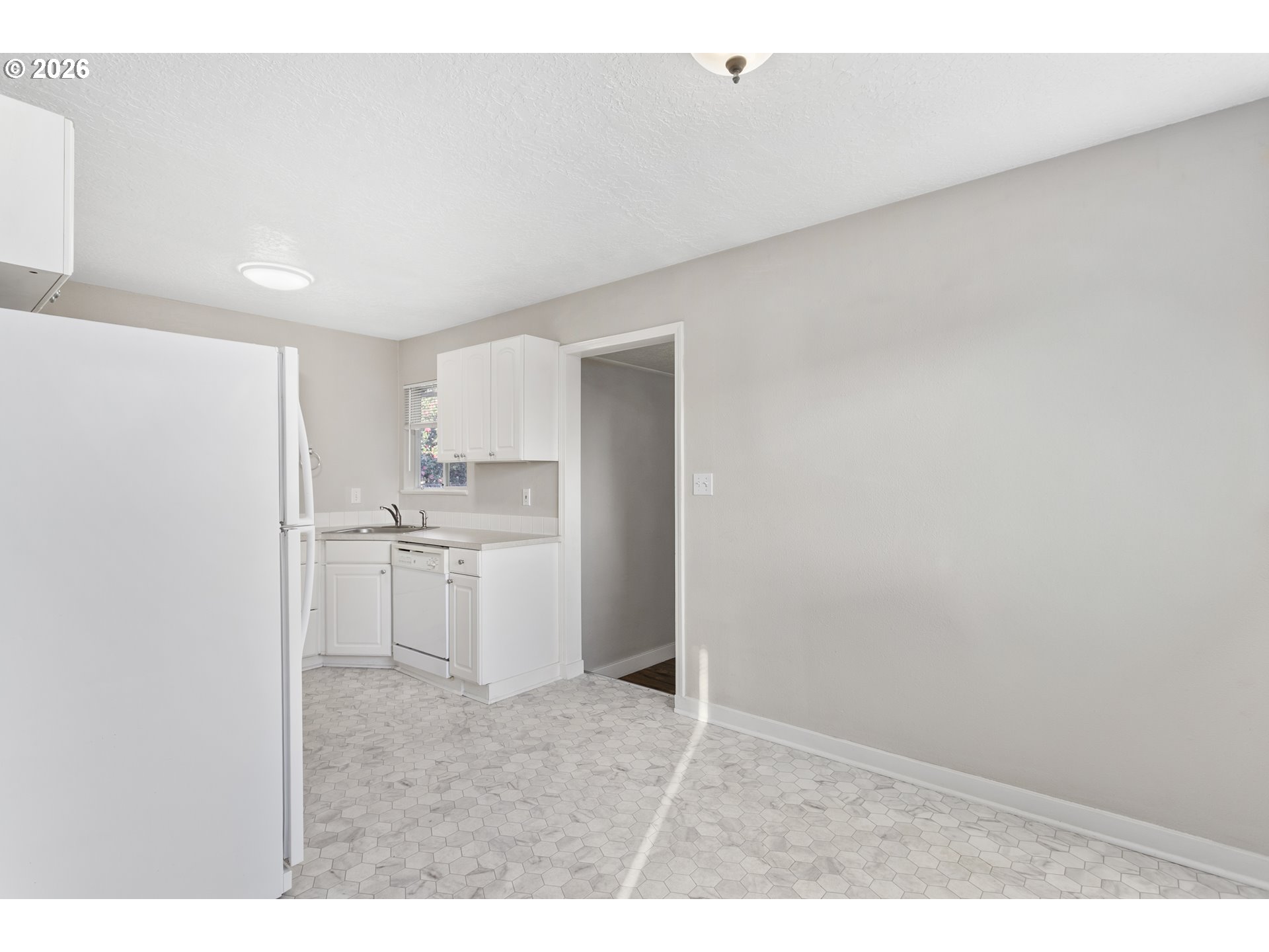 8705 Southeast Pardee Street Portland, OR 97266 - Photo 8 of 32 a kitchen with white cabinets and white appliances