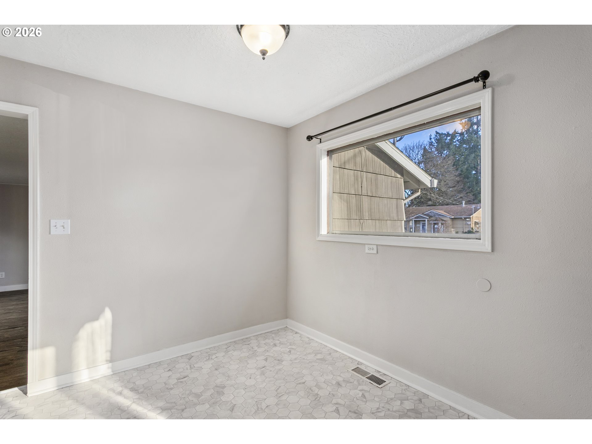 8705 Southeast Pardee Street Portland, OR 97266 - Photo 9 of 32 a view of an empty room with a window