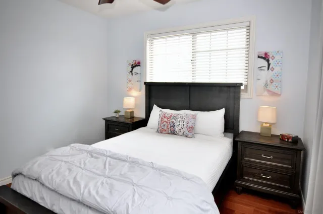 a large bed sitting in a bedroom next to a window