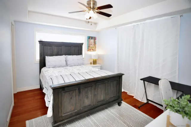 a living room with a bed furniture and a window