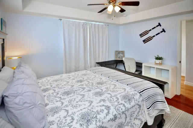 a bedroom with a bed and a chandelier