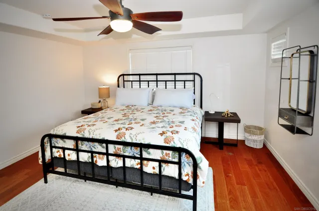 a bedroom with a bed and a tv on a dresser