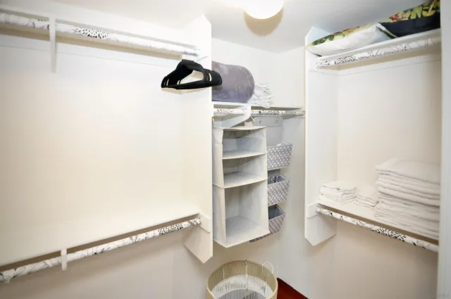 a kitchen with a refrigerator and ceiling fan