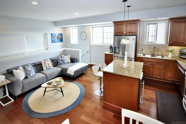 a living room with furniture a dining table and kitchen view