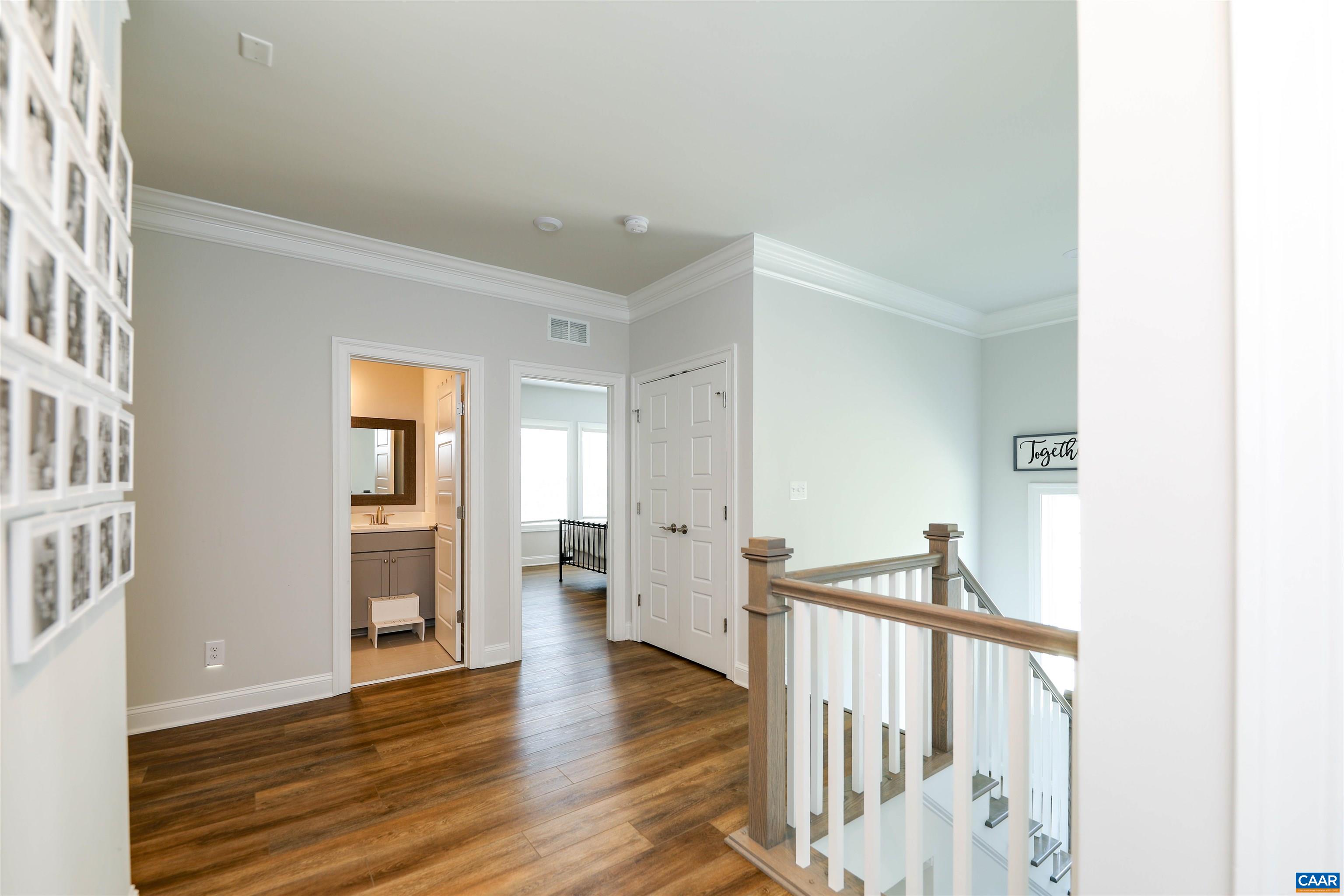 2483 Ferndown Lane Keswick, VA 22947 - Photo 21 of 54 a view of a hallway with wooden floor and windows