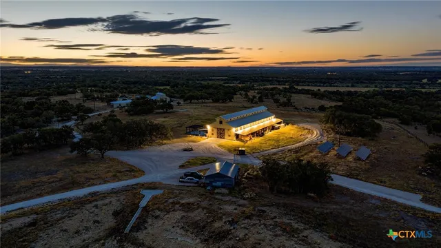 a view of swimming pool with lawn chairs and wooden fence