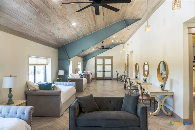 a bedroom with a bed a chair and a large window