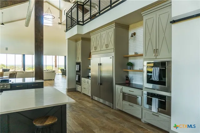 a view of living room with granite countertop lots of clutter
