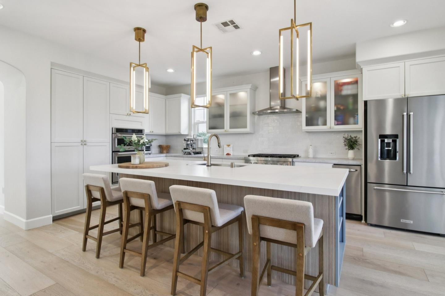 7670 MacKenzie Way Gilroy, CA 95020 - Photo 17 of 70 a kitchen with stainless steel appliances granite countertop a sink a stove a refrigerator and island with wooden floor