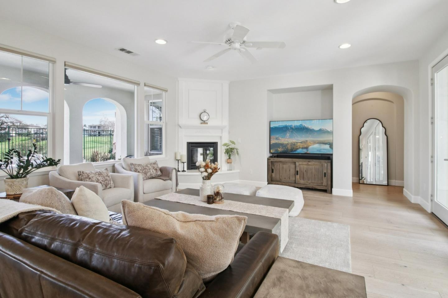 7670 MacKenzie Way Gilroy, CA 95020 - Photo 22 of 70 a living room with furniture a fireplace and a large mirror