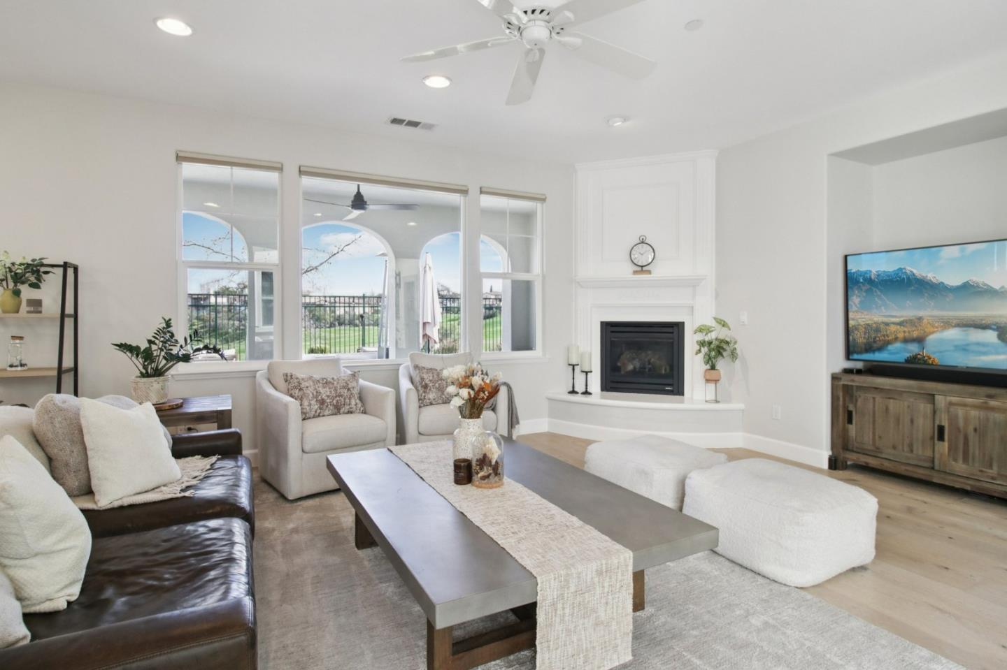 7670 MacKenzie Way Gilroy, CA 95020 - Photo 23 of 70 a living room with furniture a flat screen tv and a fireplace