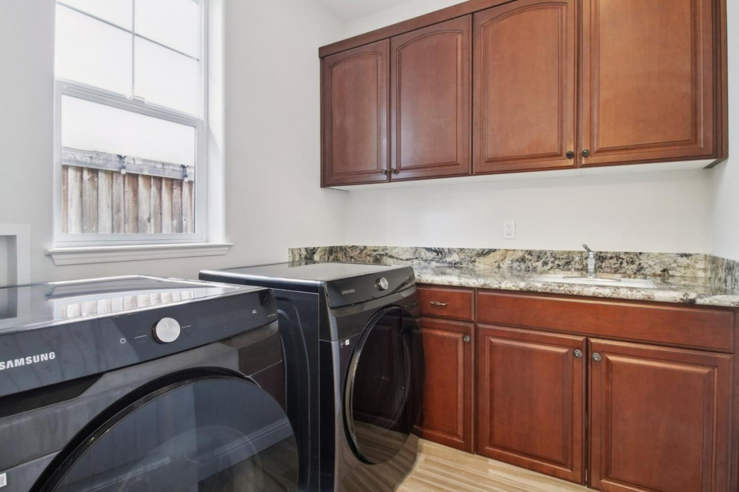 7670 MacKenzie Way Gilroy, CA 95020 - Photo 28 of 70 a utility room with granite countertop cabinets washer and dryer