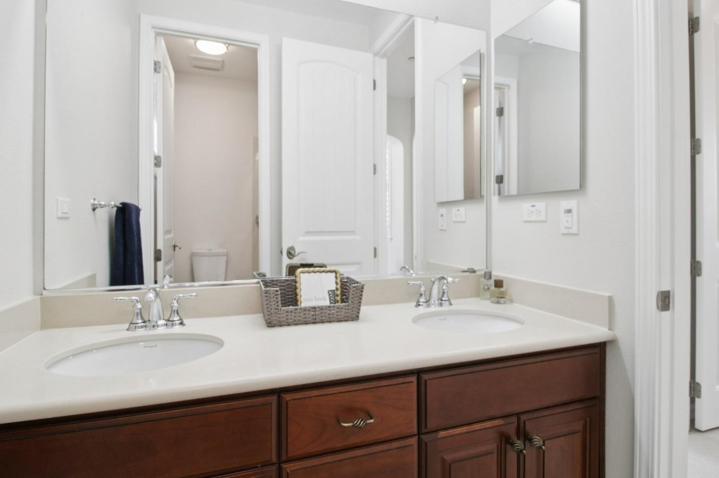 7670 MacKenzie Way Gilroy, CA 95020 - Photo 37 of 70 a bathroom with double sink and a mirror