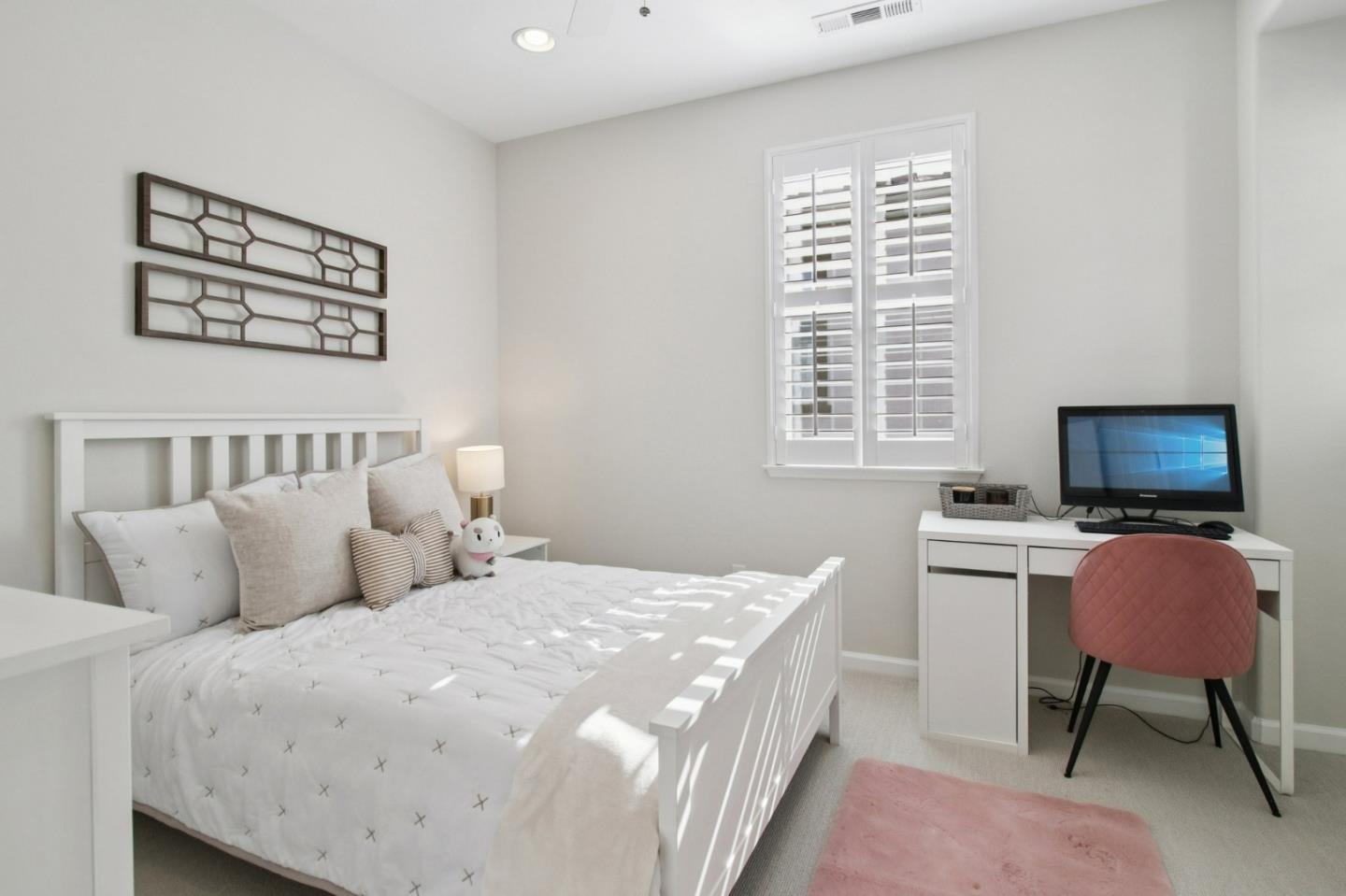 7670 MacKenzie Way Gilroy, CA 95020 - Photo 40 of 70 a bedroom with a bed and a computer on a table