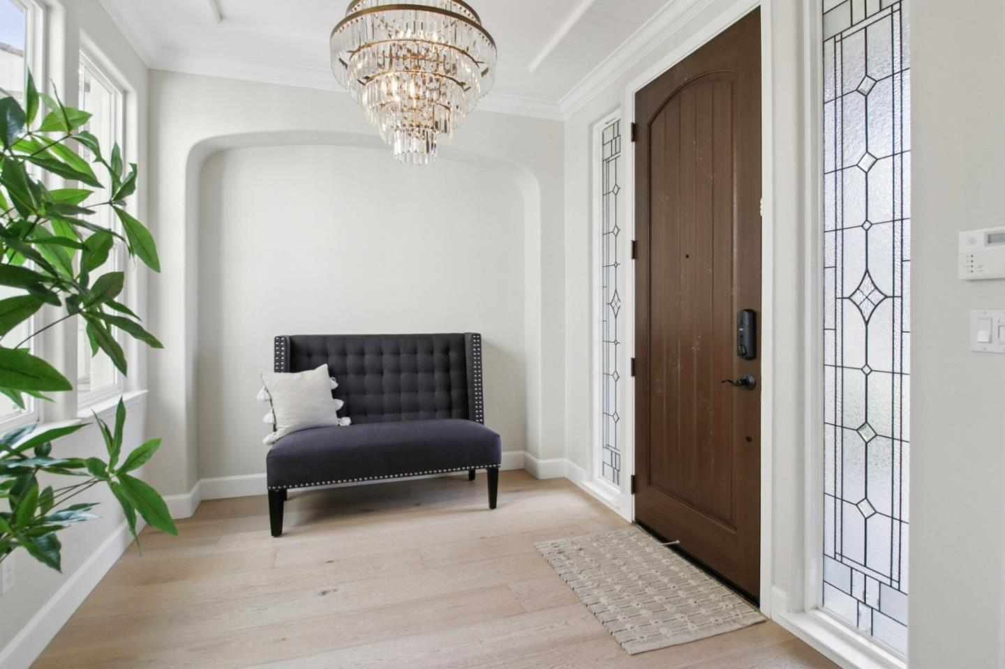 7670 MacKenzie Way Gilroy, CA 95020 - Photo 5 of 70 a bedroom with a bed and a chandelier