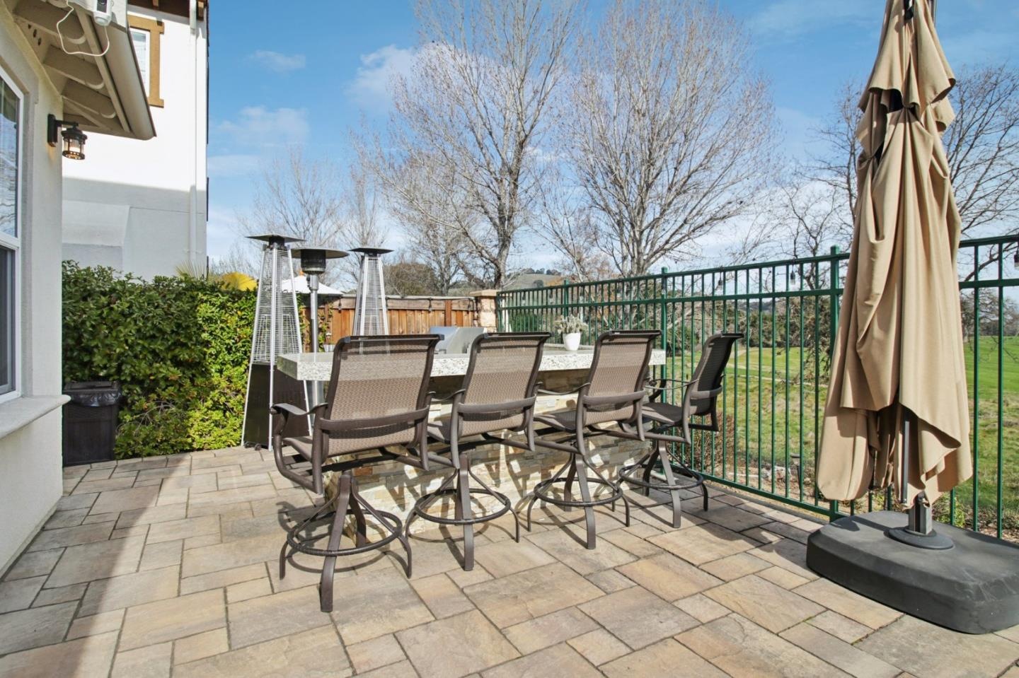 7670 MacKenzie Way Gilroy, CA 95020 - Photo 65 of 70 a view of a patio with table and chairs with wooden fence and plants