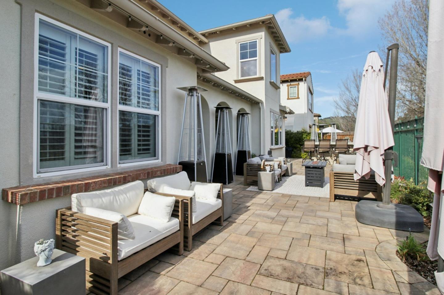 7670 MacKenzie Way Gilroy, CA 95020 - Photo 68 of 70 a view of a patio with couches table and chairs and potted plants