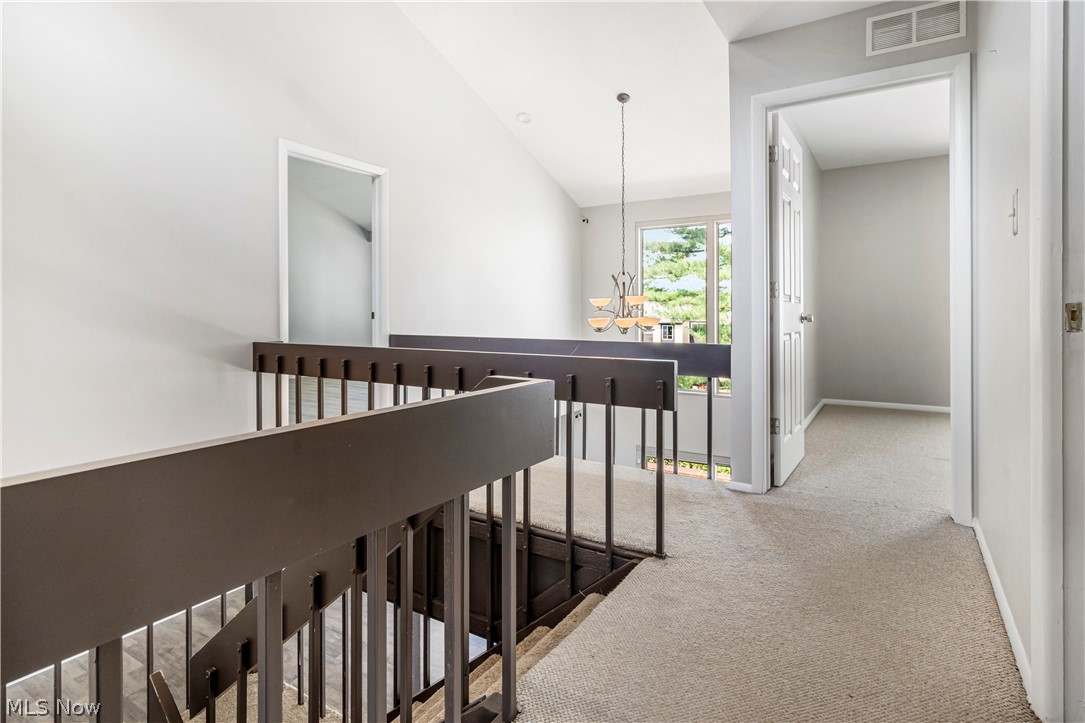 3428 South Smith Road Fairlawn, OH 44333 - Photo 7 of 30 Hallway featuring light carpet and high vaulted ceiling