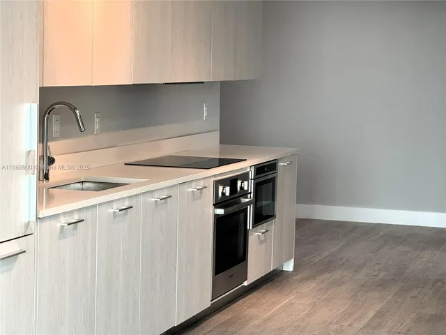 a kitchen with a stove and a sink