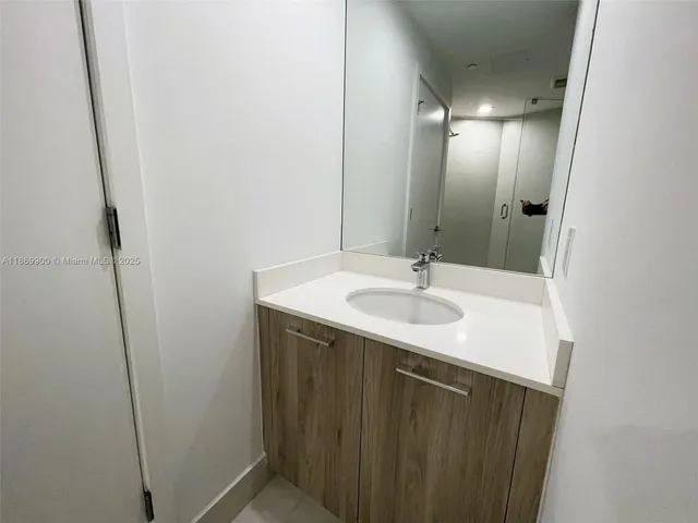 a bathroom with a sink and a mirror