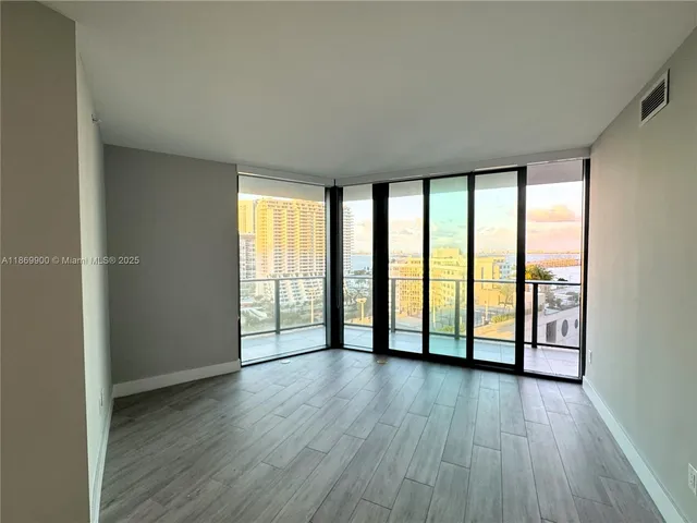 wooden floor in an empty room with windows and wooden floor