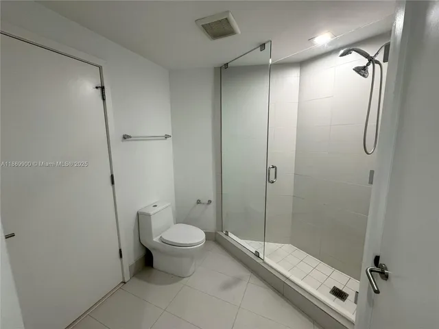 a bathroom with a granite countertop toilet sink and shower