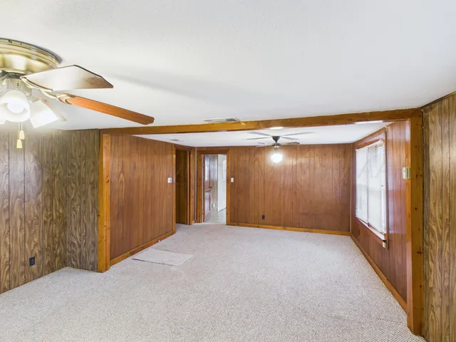 a view of a big room with windows and cabinet