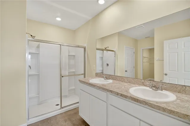 a bathroom with a glass shower door