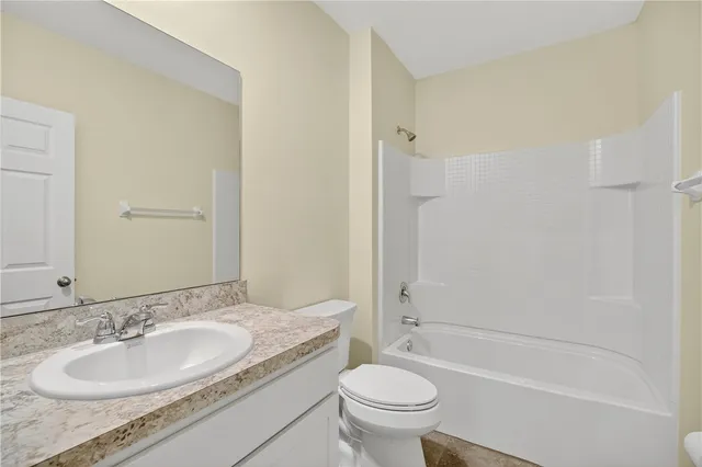 a bedroom with a bed and a potted plant