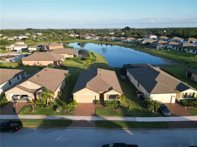 an aerial view of a houses with outdoor space lake view and mountain view in back