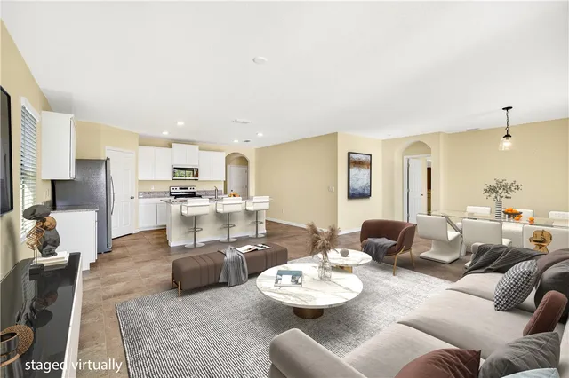 a living room with furniture and kitchen view