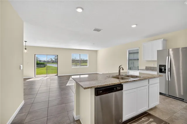 a kitchen with a sink stove and refrigerator
