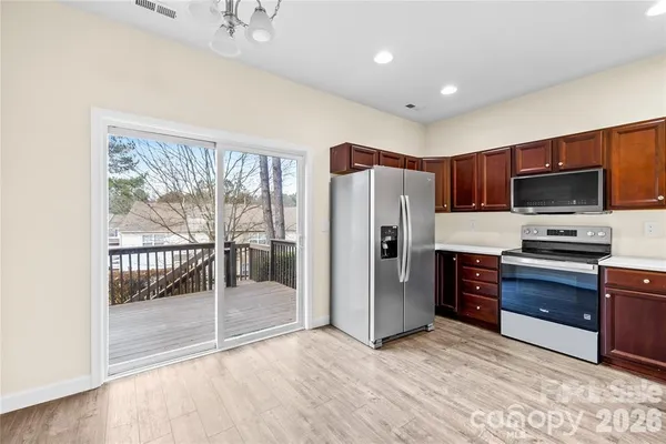 a kitchen with stainless steel appliances a refrigerator and a stove top oven