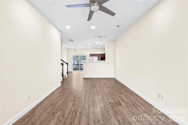 a view of a kitchen with a sink and wooden floor